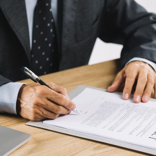 male-lawyer-signing-contract-with-pen-clipboard-540x540.jpg